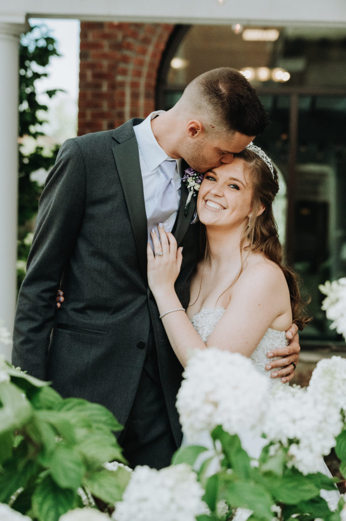 Groom Kisses Bride on the Forehead