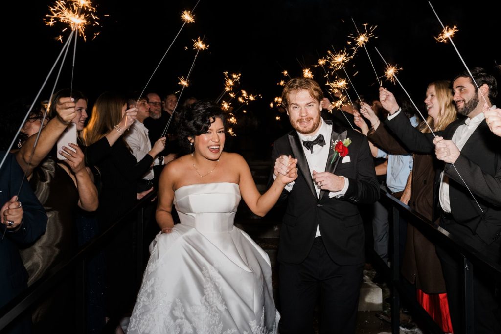 Photo of the bride and groom making an exit on their wedding day at The Wilds.