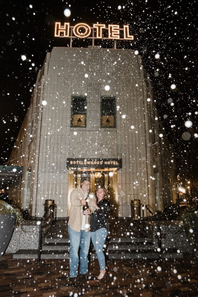 Champagne Pop engagement session photo outside the Bottleworks Hotel in Indianapolis, Indiana.